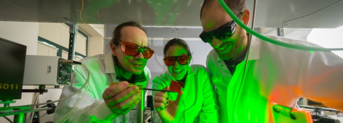 Paras N. Prasad (left), a SUNY Distinguished Professor of Chemistry, Physics, Medicine and Electrical Engineering works with students in a chemistry lab in the Natural Sciences Complex. 