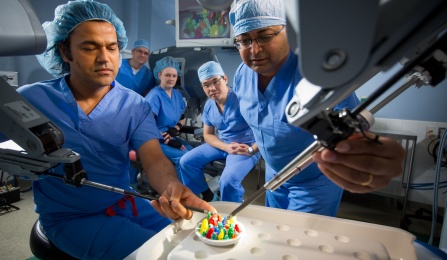 biomedical engineering faculty demonstrating robotic surgical equipment. 