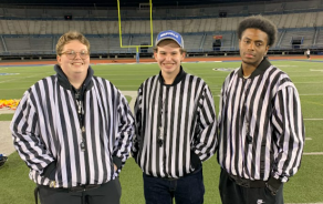 three intramural sports officials posing for a photo in their uniforms.