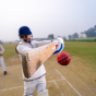 people playing cricket. 