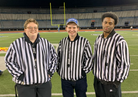 three intramural sports officials in their uniforms posing for a photo during intramural flag football league.