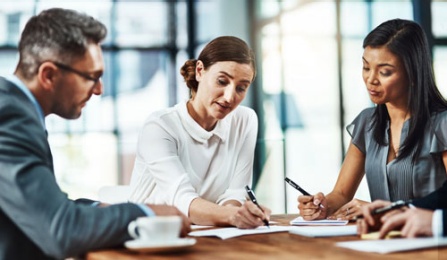 Business team reviewing documents in a boardroom.