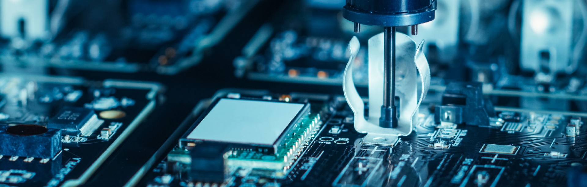 Macro shot printed circuit board assembly with robotic arm.
