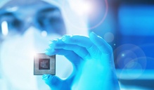 The new SUNY - NY Creates Technology Innovation Institute will advance semiconductor research and workforce development in New York State. Researcher holding microchip.