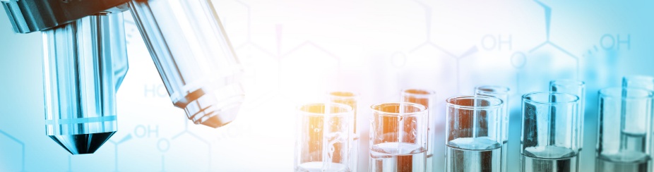 Lab instruments - microscope and test tubes.