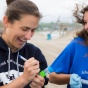 photo of students collecting water samples at Woodlawn Beach. 