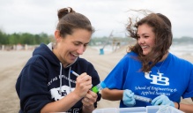 Lauren Sassoubre and Hailie Suk collecting water samples at WoodLawn Beach. 