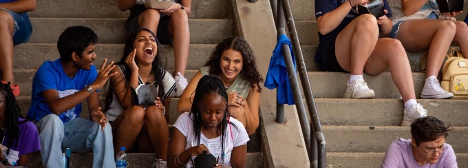 UB students sitting on steps and enjoying conversation.