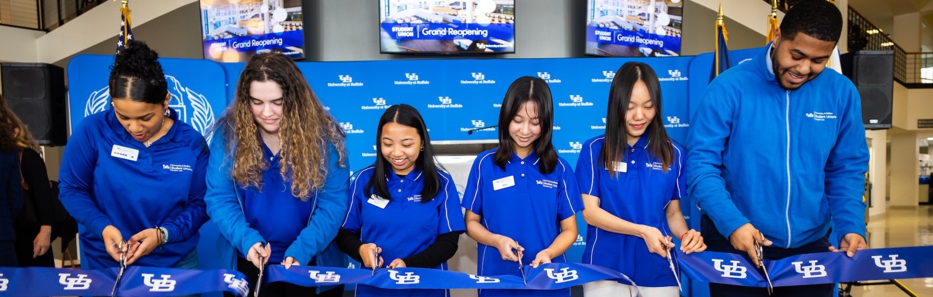 Students participating in the ribbon cutting ceremony at the Student Union grand reopening.