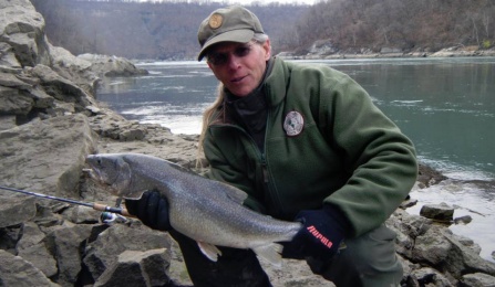 Sandy Geffner, UB adjunct professor of environmental studies, social sciences interdisciplinary, with a catch-and-release lake trout from the Lower Niagara River.
