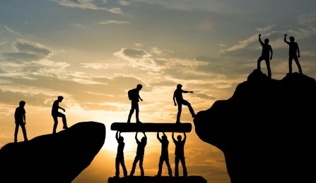 Silhouette of people on a mountain.