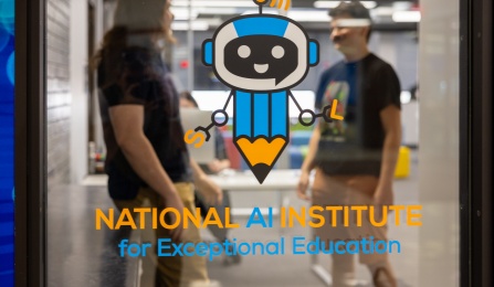 View through the window of the National AI Institute for Exceptional Education. The window depicts the institute's logo. 