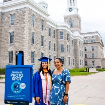 Two people posing in front of Hayes Hall.