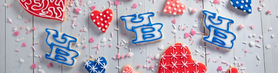 UB cookies displayed among red heart-shaped cookies. 