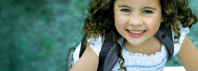 picture of a little girl smiling at the camera.