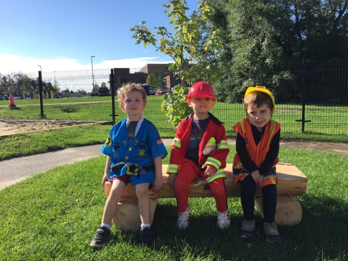 3 preschool children sitting on Joel's bench.