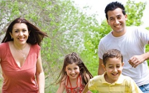 family of four with smiles.