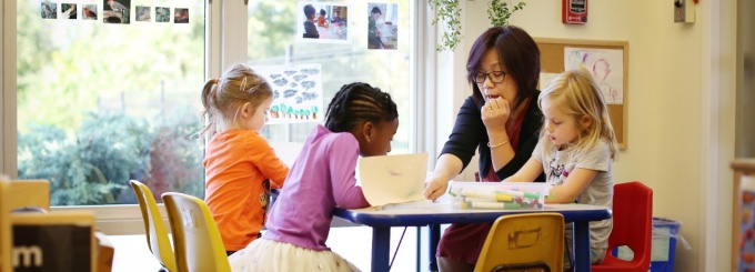 Photo - Preschool teacher and children reading.