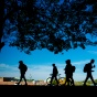 Students in silhouette on devices (photo by Douglas Levere). 