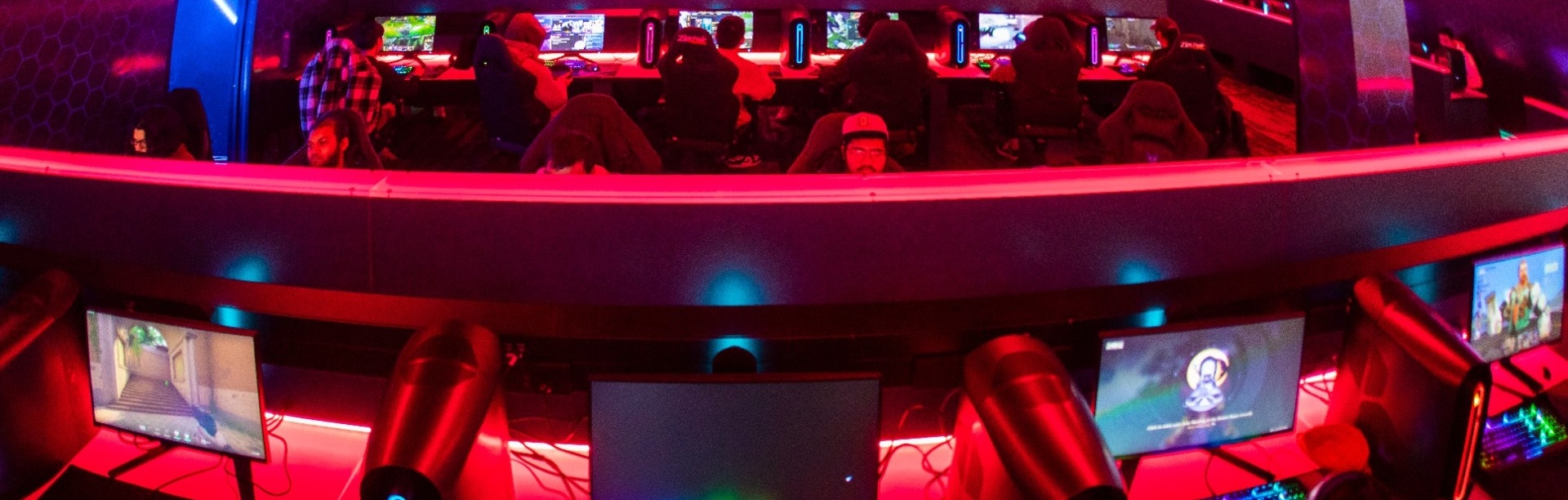 gamers in a dimly lit Level Up esports arena.