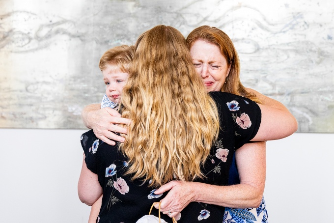 Sandy Flash hugging a young boy and his mother. 