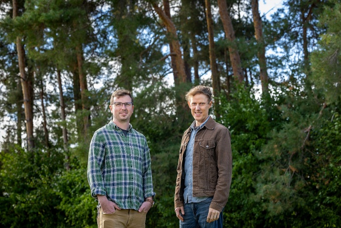 John Fiege and Kacey Stewart standing in the woods. 