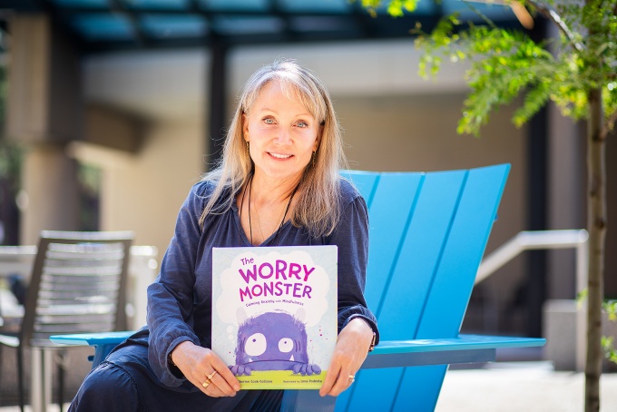 Catherine Cook-Cottone holds a copy of The Worry Monster kids book. 