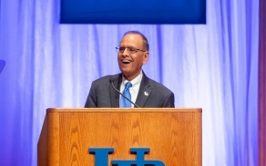 President Satish K. Tripathi speaking from behind a podium. 