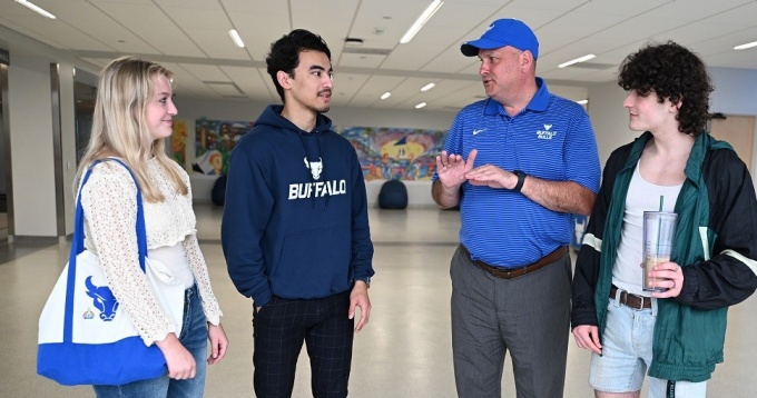 Vice President for Student Life, Brian Hamluk meeting with students on campus. 