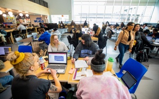 Zoom image: Students and others meet, study, and socialize in the spaces of One World Café in March 2022. Photographer: Douglas Levere