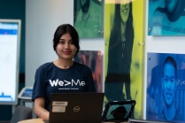 Ekamjot Kaur Khaira standing at a table with a laptop. 