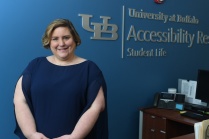 Kristy Harte standing in front of a sign for UB Accessibility Resources.