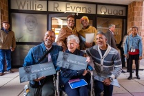 The Evans family pose together for photos in front of the doorway bearing his name.
